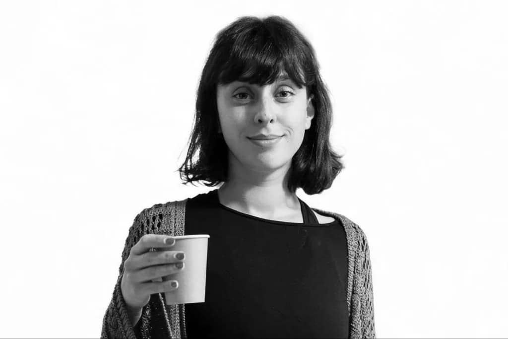 Founder of Ledger holding a clipboard and a coffee