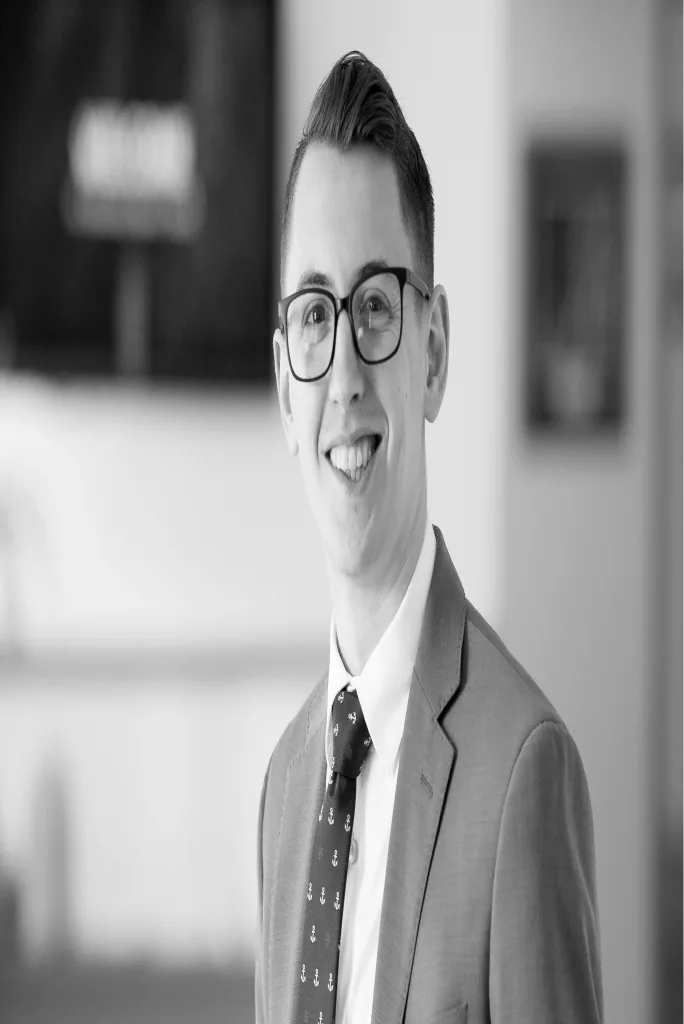 Co-founder of Uplist in a suit, smiling